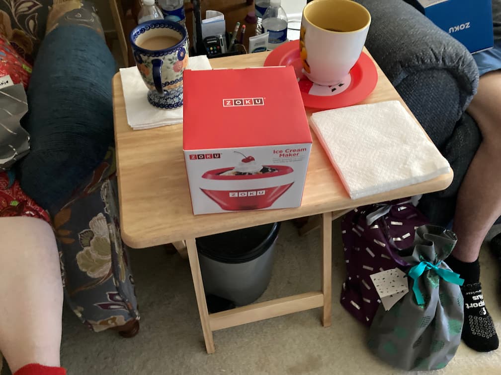 A Zoku ice cream maker bowl, in box, sitting on a tray table